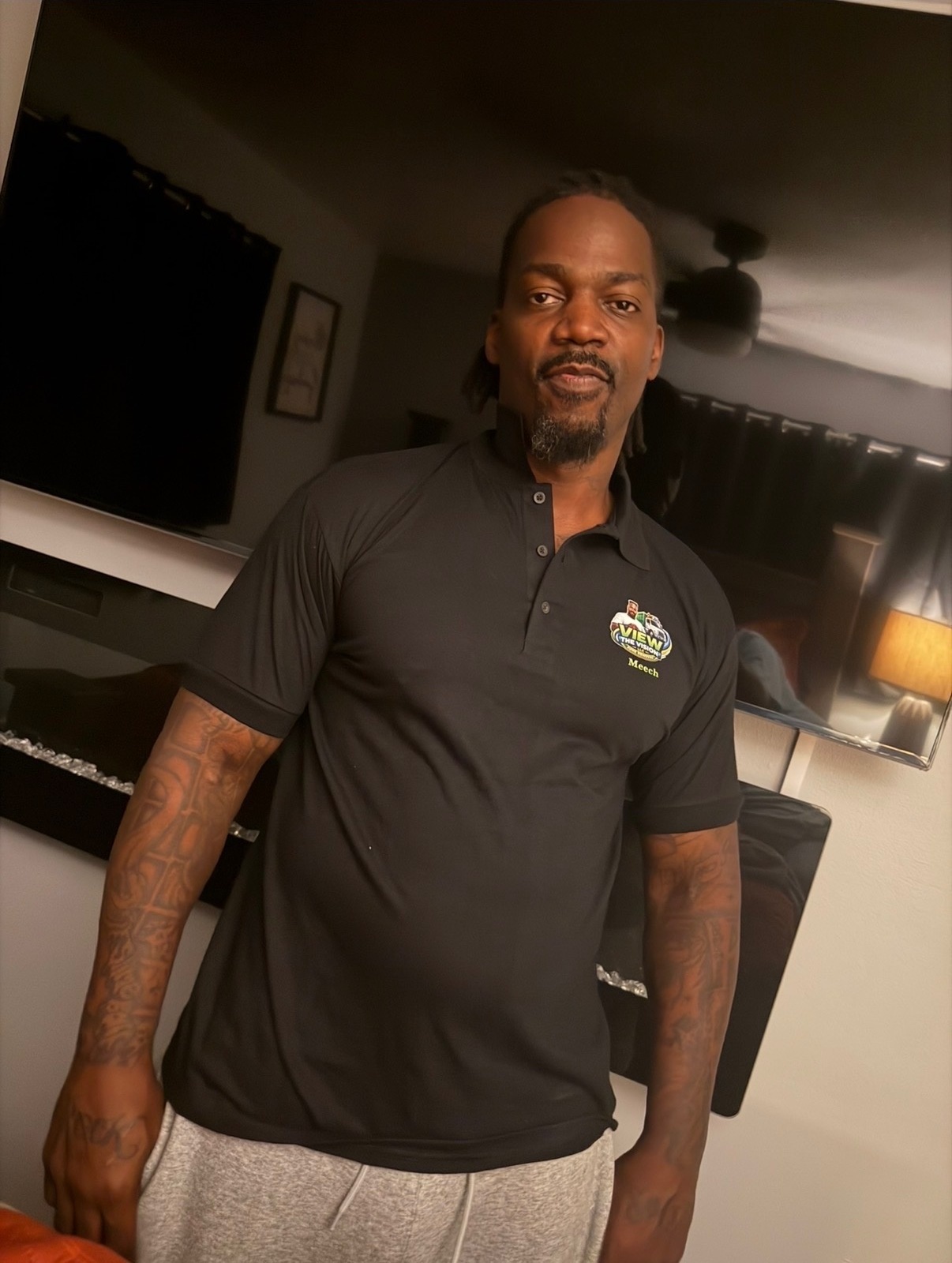 Meech, co-owner of View the Vision LLC, in a black VIEW polo shirt