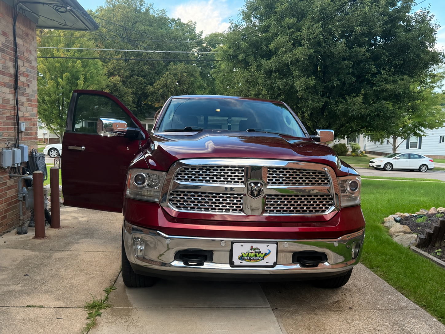 The View the Vision truck, a maroon Ram pickup, parked on a driveway